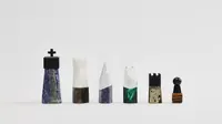 Six unique, handcrafted chess pieces from Joe Burrow's "The Unfinished Set" are displayed on a white background