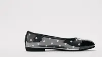A single PinkPantheress custom ballet flat, black with white polka dots and a glossy black toe cap, is shown on a white background